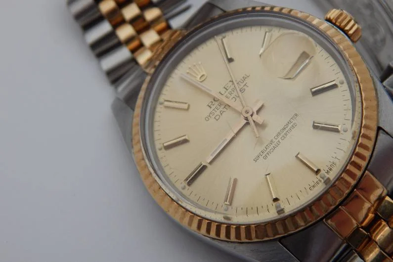 Gold Silver Rolex watch in white background